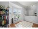 Cozy sunroom featuring hardwood floors, storage solutions, and bright windows with natural light at 2833 Gross Ave, Wake Forest, NC 27587