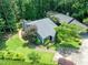 Overhead view of gray home with large roof, mature trees and landscaped yard at 2849 Rue Sans Famille, Raleigh, NC 27607