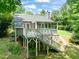 Backyard featuring multi-level deck with screened-in porch, landscaping, and stairs into the yard at 2849 Rue Sans Famille, Raleigh, NC 27607