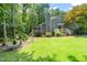 Well-maintained backyard showcasing the home's exterior, back deck, and lush greenery at 2849 Rue Sans Famille, Raleigh, NC 27607