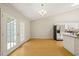 Bright dining area featuring wood floors, chandelier and double doors leading outside at 2849 Rue Sans Famille, Raleigh, NC 27607