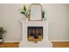 Close-up of fireplace, baskets, mirror, and plants set against neutral walls and flooring at 2849 Rue Sans Famille, Raleigh, NC 27607