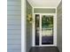 Welcoming front door with wreath, sidelight and views of the outdoor scenery at 2849 Rue Sans Famille, Raleigh, NC 27607