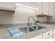 Granite countertops and stainless steel sink and faucet in modern kitchen at 2849 Rue Sans Famille, Raleigh, NC 27607