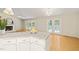 Close-up of a kitchen island featuring granite countertops, white cabinets, and an open view to the living room at 2849 Rue Sans Famille, Raleigh, NC 27607