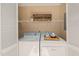 Bright laundry room with shelving, laundry room sign and white appliances at 2849 Rue Sans Famille, Raleigh, NC 27607