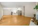 Open-concept living area with wood floors, leading to the dining area and kitchen at 2849 Rue Sans Famille, Raleigh, NC 27607
