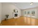 Bright living room boasts wood flooring, fireplace, vaulted ceilings, and access to the porch at 2849 Rue Sans Famille, Raleigh, NC 27607