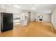 Open-concept living room with a fireplace, skylights, and a kitchen featuring an island with granite countertops at 2849 Rue Sans Famille, Raleigh, NC 27607