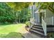 Landscaped side yard featuring green lawn, mature trees, and stone pathway at 2849 Rue Sans Famille, Raleigh, NC 27607