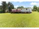 Large, green backyard with a deck, perfect for outdoor living and entertaining at 2932 Bramblegate Dr, Mebane, NC 27302