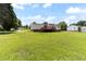 Expansive backyard featuring lush green grass and a wooden deck on a well-maintained home at 2932 Bramblegate Dr, Mebane, NC 27302