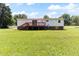 Spacious backyard with well-maintained lawn, deck, and charming home exterior at 2932 Bramblegate Dr, Mebane, NC 27302