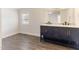 Bathroom featuring modern double sink vanity, framed mirror, and vinyl flooring at 2932 Bramblegate Dr, Mebane, NC 27302
