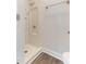 Bathroom featuring walk-in shower with white tiled surround and chrome shower head at 2932 Bramblegate Dr, Mebane, NC 27302