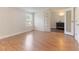 Bright bedroom featuring wood floors, a window, and ensuite bathroom with double doors at 2932 Bramblegate Dr, Mebane, NC 27302