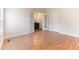 Bright bedroom featuring wood floors, a window, and ensuite bathroom with double doors at 2932 Bramblegate Dr, Mebane, NC 27302