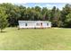 Well-maintained house set on a spacious grassy lot with mature trees at 2932 Bramblegate Dr, Mebane, NC 27302