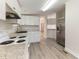 Updated kitchen with white cabinets, stainless steel appliances, and modern flooring at 2932 Bramblegate Dr, Mebane, NC 27302