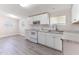 Kitchen with white cabinets, white appliances, neutral countertops and vinyl flooring at 2932 Bramblegate Dr, Mebane, NC 27302
