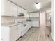 Bright kitchen features white cabinets, updated countertops, and modern appliances at 2932 Bramblegate Dr, Mebane, NC 27302