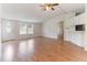 Bright living room featuring wood floors, large windows, and a view to the kitchen at 2932 Bramblegate Dr, Mebane, NC 27302