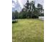Fenced backyard with luscious green lawn and tall trees in the background at 3 Meadowrue Ln, Youngsville, NC 27596