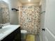 Bathroom with shower, sink, floral curtain, and tile flooring at 3 Meadowrue Ln, Youngsville, NC 27596