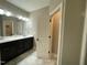 Bathroom featuring a double sink vanity with modern fixtures and an open doorway to another room at 3 Meadowrue Ln, Youngsville, NC 27596