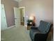 Cozy sitting area in the bedroom, complete with an accent chair and a lamp-lit side table at 3 Meadowrue Ln, Youngsville, NC 27596