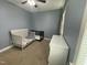 A bedroom featuring a crib and toddler bed, plus a white dresser and neutral colored carpet at 3 Meadowrue Ln, Youngsville, NC 27596