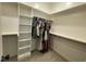Spacious walk-in closet with built-in shelving and hanging rods for optimal storage and organization at 3 Meadowrue Ln, Youngsville, NC 27596