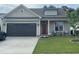 Charming single-story home featuring a cozy front porch and a well-manicured lawn at 3 Meadowrue Ln, Youngsville, NC 27596