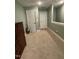 Hallway with carpet flooring leading to rooms, featuring a classic wooden dresser and guitar in view at 3 Meadowrue Ln, Youngsville, NC 27596