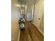 Hallway with hardwood floors, white trim, and neutral paint, leading to other rooms at 3 Meadowrue Ln, Youngsville, NC 27596