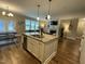 Open-concept kitchen featuring an island with granite countertops, a double sink, and stainless steel appliances at 3 Meadowrue Ln, Youngsville, NC 27596