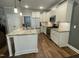 Modern kitchen with white cabinetry, granite countertops, stainless steel appliances, and a large island at 3 Meadowrue Ln, Youngsville, NC 27596