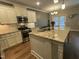 Well-equipped kitchen with white cabinets, granite counters, stainless steel appliances, and center island at 3 Meadowrue Ln, Youngsville, NC 27596