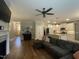 Open-concept living room featuring a fireplace, comfortable furnishings, and hardwood floors at 3 Meadowrue Ln, Youngsville, NC 27596
