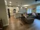 Open-concept living room featuring a large sectional sofa and a view of the kitchen at 3 Meadowrue Ln, Youngsville, NC 27596