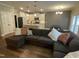 Open-concept living room featuring a large sectional sofa and a view of the kitchen at 3 Meadowrue Ln, Youngsville, NC 27596