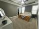 Calm main bedroom featuring large window, ceiling fan, and neutral tones at 3 Meadowrue Ln, Youngsville, NC 27596