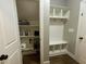 Well-organized pantry with shelving for ample storage, complemented by mudroom with bench and hooks at 3 Meadowrue Ln, Youngsville, NC 27596
