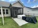 View of a screened porch area with concrete flooring and dark trim, as well as covered outdoor furniture at 3 Meadowrue Ln, Youngsville, NC 27596