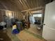 Unfinished room featuring exposed framing, storage containers, and natural light from the window at 3 Meadowrue Ln, Youngsville, NC 27596