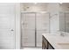 Close up of glass shower doors and double vanity in bathroom with wood-look flooring at , Fuquay Varina, NC 27526