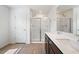 Bathroom highlighting a double vanity, glass shower doors, and wood-look flooring at , Fuquay Varina, NC 27526