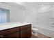 Well-lit bathroom with a dark vanity, modern fixtures, and a shower-tub combination at , Fuquay Varina, NC 27526