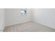 Empty bedroom featuring neutral carpet and a window with a neighborhood view at , Fuquay Varina, NC 27526