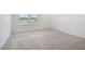 Bright, empty bedroom featuring neutral carpet and a window with neighborhood views at , Fuquay Varina, NC 27526